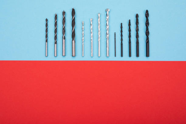 Set of drills are spread out in a row on red-blue background Set of drills are spread out in a row on red-blue background make over series stock pictures, royalty-free photos & images