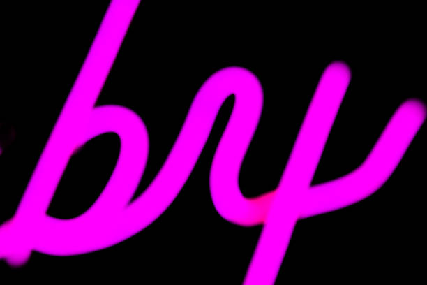 Abstact blurred purple neon sign on black background.