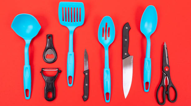 istock Cooking utensils in kitchen isolated on red background 1132918854