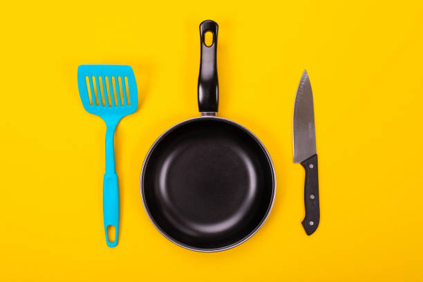 istock Kitchen utensils for cooking in kitchen isolated with copyspace on yellow background 1132918868