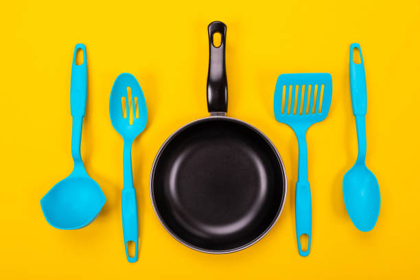 istock Kitchen utensils for cooking in kitchen isolated with copyspace on yellow background 1132918876