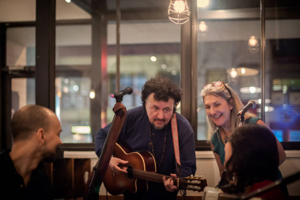istock Multi-Ethnic Mature Musicians in Live Band Having Discussion Between Songs 1132918973