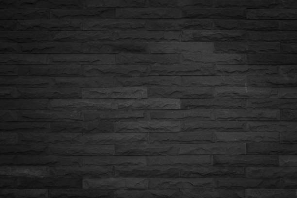 istock Seamless Black pattern of decorative brick sandstone wall surface with concrete of modern style design decorative uneven have cracked realmasonry wall of multicolored stones or blocks white cement. 1132919351