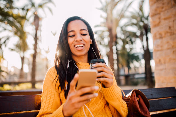 istock Girl sitting on the bench and using phone 1132921146