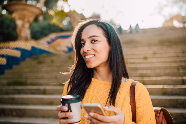 istock Girl with coffee cup and mobile phone 1132921234