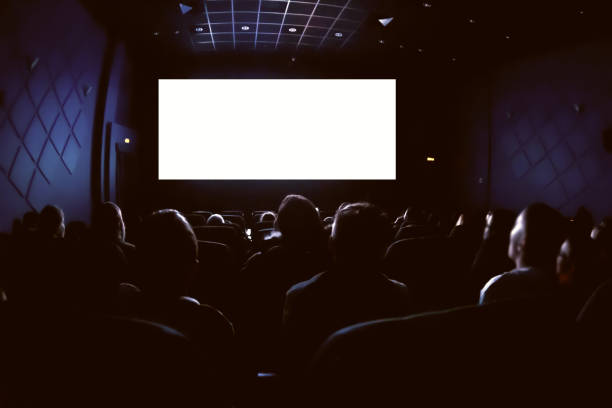 istock People in the cinema watching a movie. Blank empty white screen 1132922092