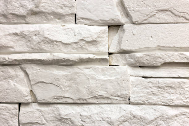 istock Close-up of white solid limestone wall or stone fence. Abstract copy space background, Bricklaying, construction and masonry concept. 1132922723