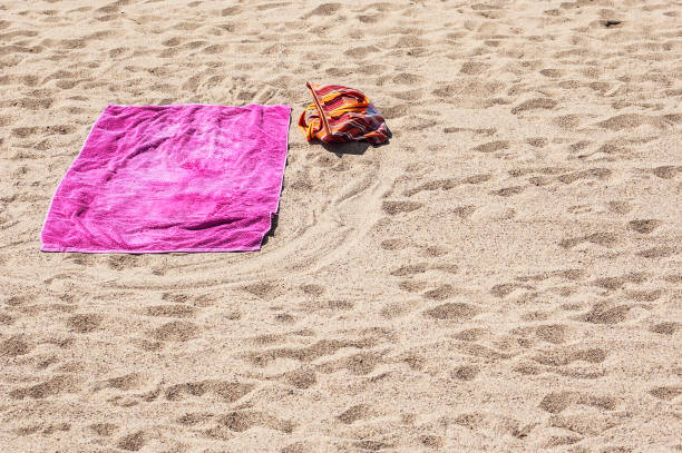 istock Lonely beach towel on sandy plage. 1132922804