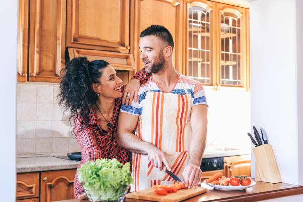 istock Couple in love cooking at home 1132927366