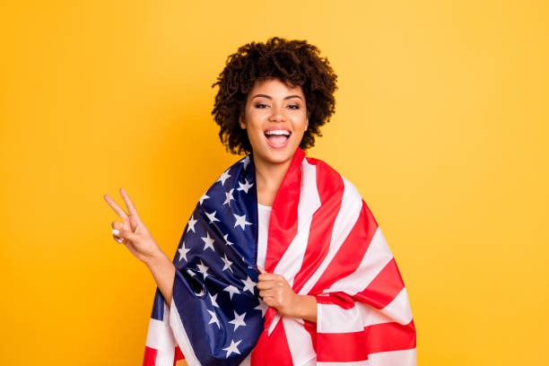 istock Portrait of her she nice charming attractive beautiful cheerful optimistic wavy-haired lady covered wrapped in us flag showing v-sign isolated over bright vivid shine background 1132928522