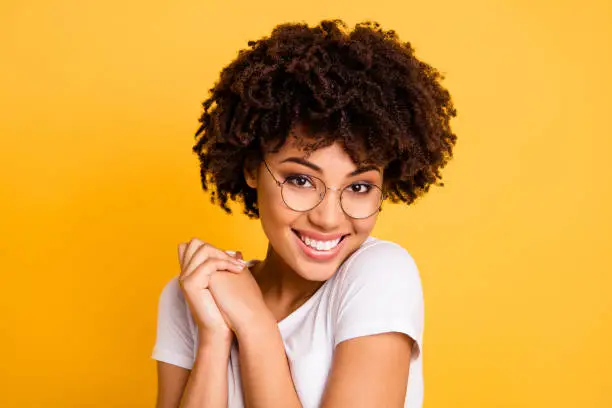 Close-up portrait of her she nice cute charming attractive beautiful cheerful pleased wavy-haired lady eyeglasses eyewear holding hands isolated over bright vivid shine background.