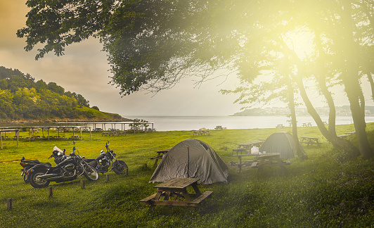 Tent camping and motorcycles at sunset