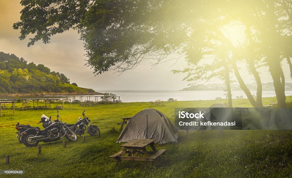 Tent camping Tent camping and motorcycles at sunset Motorcycle Stock Photo