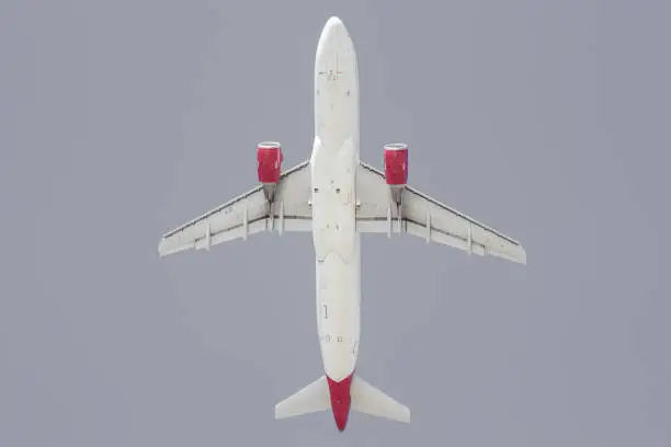 Passenger Airplane being on a short final just prior to landing. View from front and below.