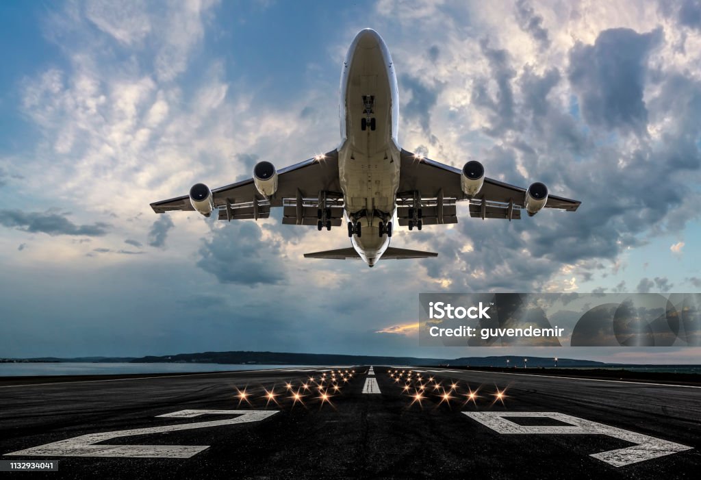 Passenger airplane taking off at sunset Airplane Stock Photo