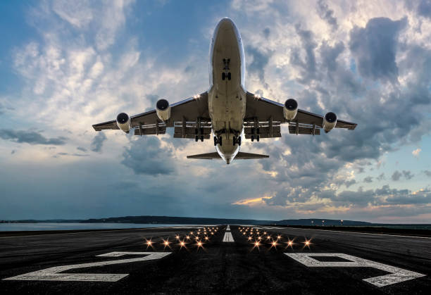 passenger airplane taking off at sunset - taking off imagens e fotografias de stock