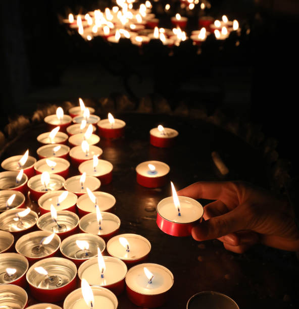 istock boy putting a candle and recites a prayer for his school results 1132934233