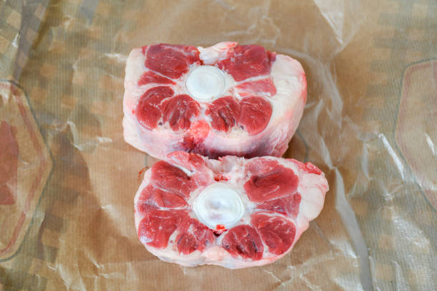 istock Fresh cutting raw oxtail or beef with bone, tail path of cow on white plate and white background. Oxtail is a gelatin-rich meat, which is usually slow-cooked as a stew. 1132935272
