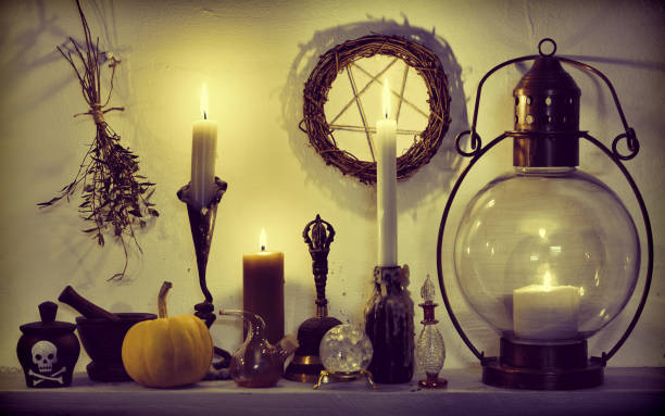 istock Herbs, pumpkin, crystals, vintage lamp and pentagram on witch table 1132937149