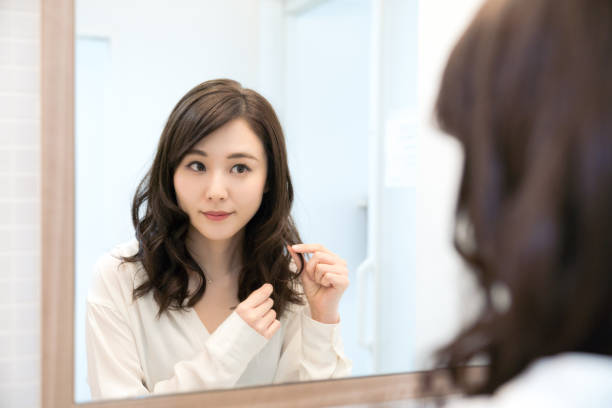 istock Young asian woman looking a mirror. 1132939600