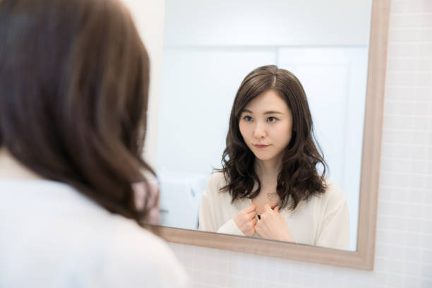 istock Young asian woman looking a mirror. 1132939608