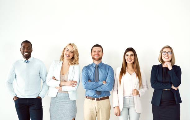 They're all about the confidence Portrait of a group of confident work colleagues standing with their arms folded against a white background people in a row photos stock pictures, royalty-free photos & images
