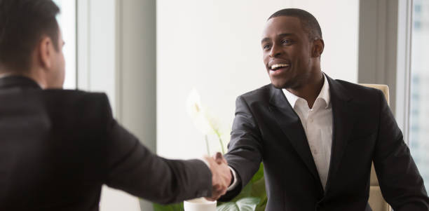 Horizontal image black and caucasian businesspeople starting negotiations shaking hands African boss shake hands with business partner gather at office for negotiations, job interview human resources, client and executive manager concept, horizontal photo banner for website header design narrow photos stock pictures, royalty-free photos & images