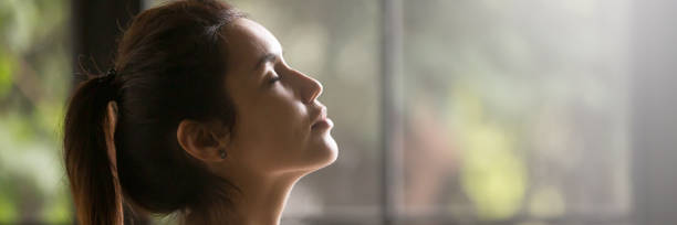 istock Side view beautiful woman with closed eyes enjoying fresh air 1132941105