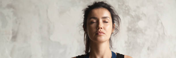 istock Horizontal image beautiful woman face with closed eyes practicing yoga 1132941108