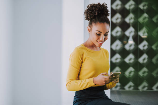 istock Charming afro american girl using cellphone at office 1132941794