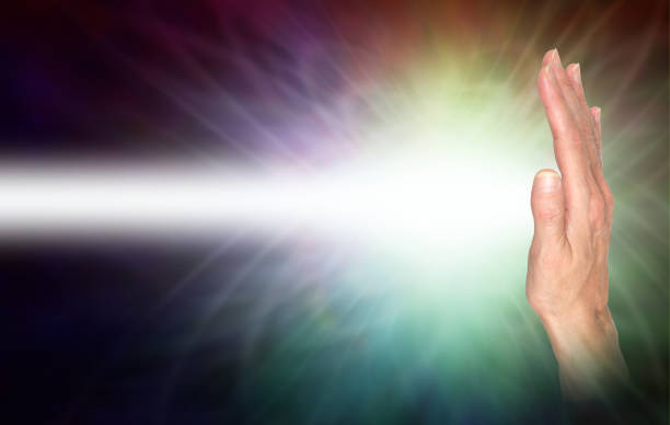 female hand facing out with a beam of white energy streaming out and copy space
