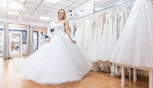 istock Cute bride dancing in bridal shop 1132945790