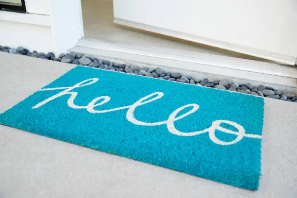 Photo of Doormat Outside Open Front Door Of House