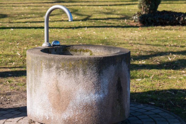 istock Concrete fountain with water dispenser in a park 1132949332