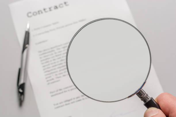 Contract with empty magnifying glass as a template for further processing template, contract law read the fine print stock pictures, royalty-free photos & images