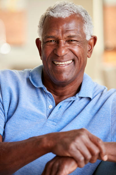 istock Portrait Of Smiling Senior Man Relaxing On Sofa At Home 1132950607