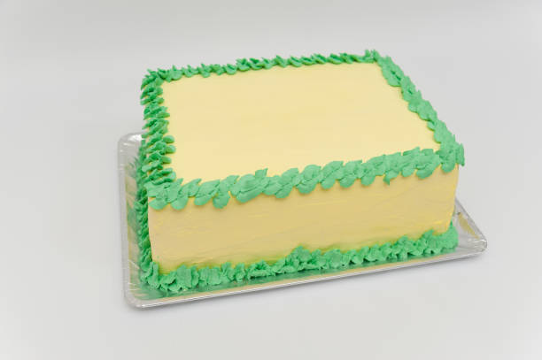 Birthday cake with green and yellow colors. Horizontal image. Side view. Birthday cake with green and yellow colors. Isolated on white background. Horizontal image. Side view. birthday cake green stock pictures, royalty-free photos & images