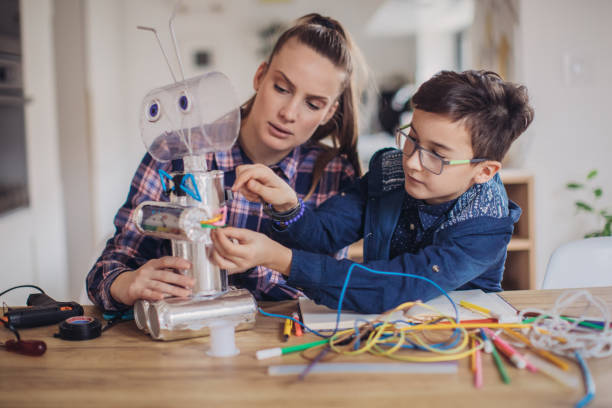 istock Boy making robot toy of recycling material for school project 1132952445