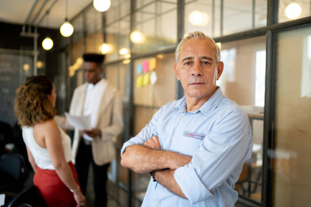 istock Senior businessman portrait at startup modern office 1132952452