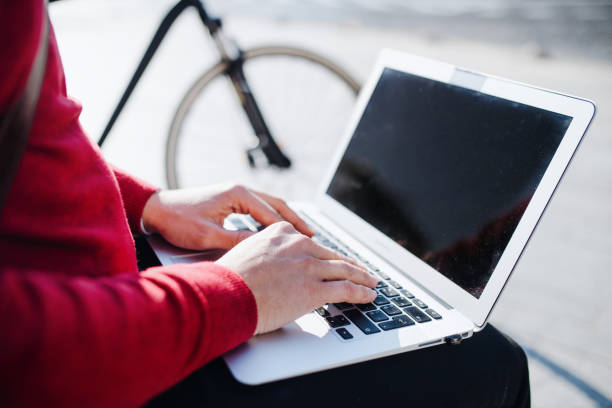 istock A midsection of businessman sitting on bench in city, using laptop. Copy space. 1132953067