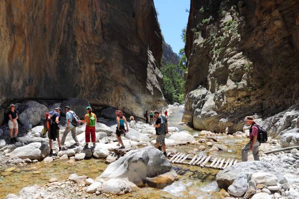 Samaria, Crete Tourists hike in Samaria Gorge in Crete, Greece. The national park is a UNESCO Biosphere Reserve since 1981. lefka ori photos stock pictures, royalty-free photos & images