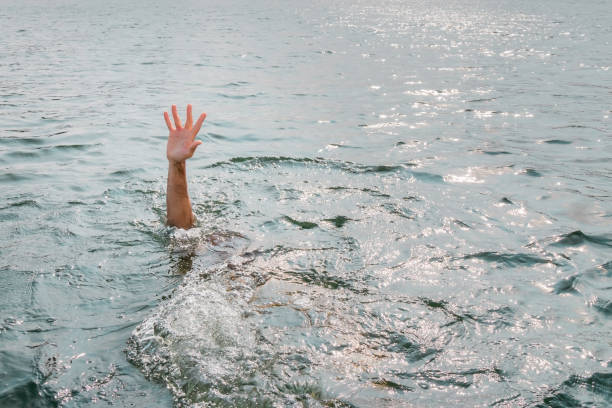 istock Drowning man, asking for help. Sticking hand out of water. 1132953773
