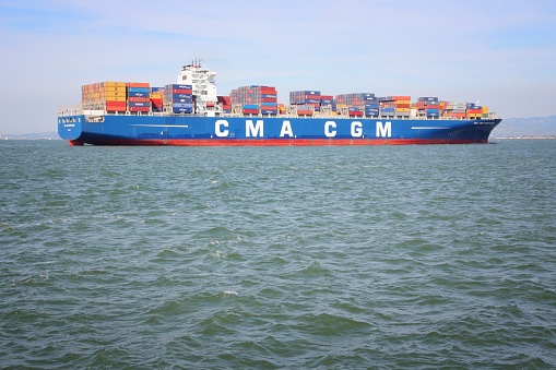 SAN FRANCISCO, USA - APRIL 8, 2014: CMA CGM Centaurius container ship sails in San Francisco bay. CMA CGM is the 3rd largest container shipping company in the world with 170 routes.