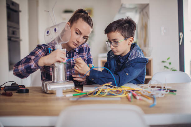 istock Boy making robot of recycling material for school project 1132954602