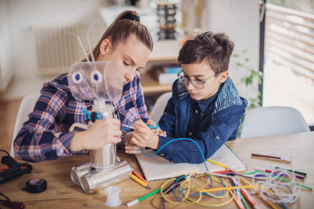 istock Boy making robot of recycling material for school project 1132954699