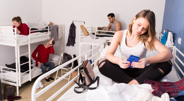 istock Girl with phone on bed in hostel 1132956335