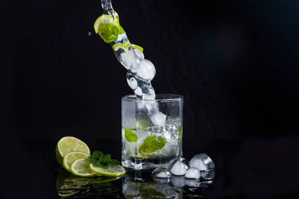 istock Summer cocktail mojito with splash on black background. 1132956801