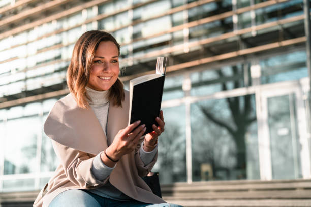 istock Female student is reading a book on campus 1132957876
