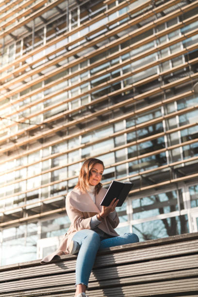 istock Female student is reading a book on campus 1132957884