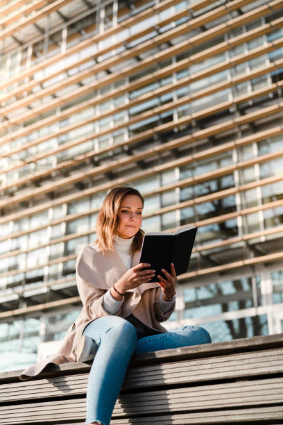istock Female student is reading a book on campus 1132957897
